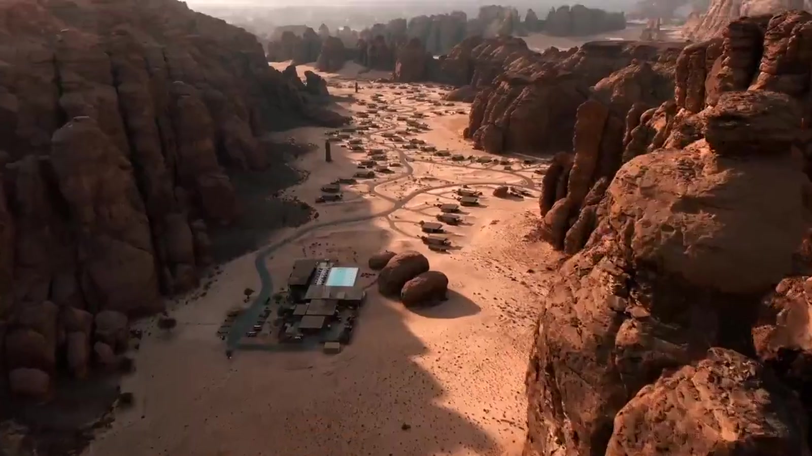 Demonstration frame — aerial view of a desert retreat at first light